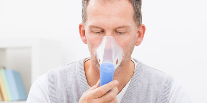 Image of man using nebulizer